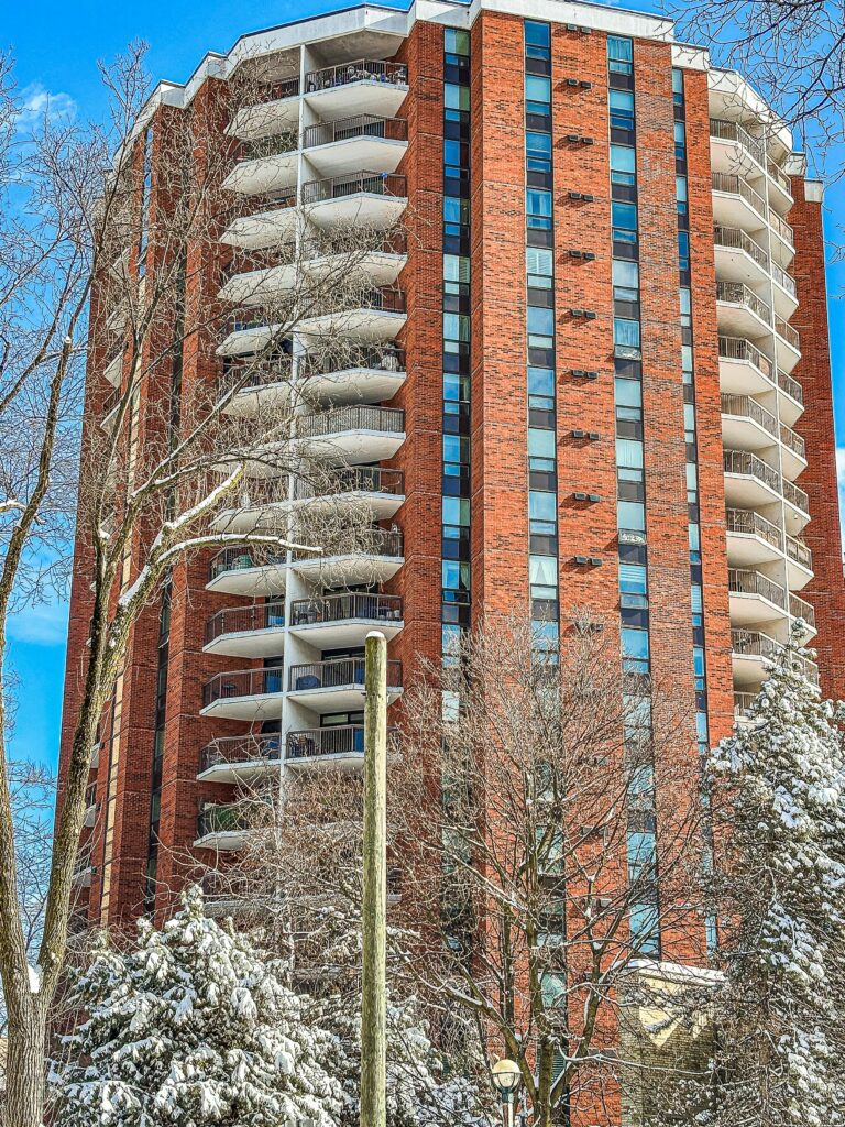 A modern high-rise building in downtown Toronto during winter season.